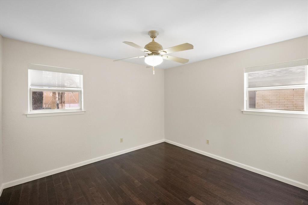 2003 Botts Drive Arlington, TX 76012 - Photo 29 of 40 a view of a room with wooden floor and a ceiling fan