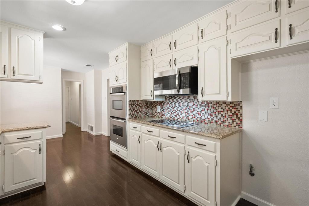 2003 Botts Drive Arlington, TX 76012 - Photo 9 of 40 a kitchen with stainless steel appliances granite countertop a sink and cabinets