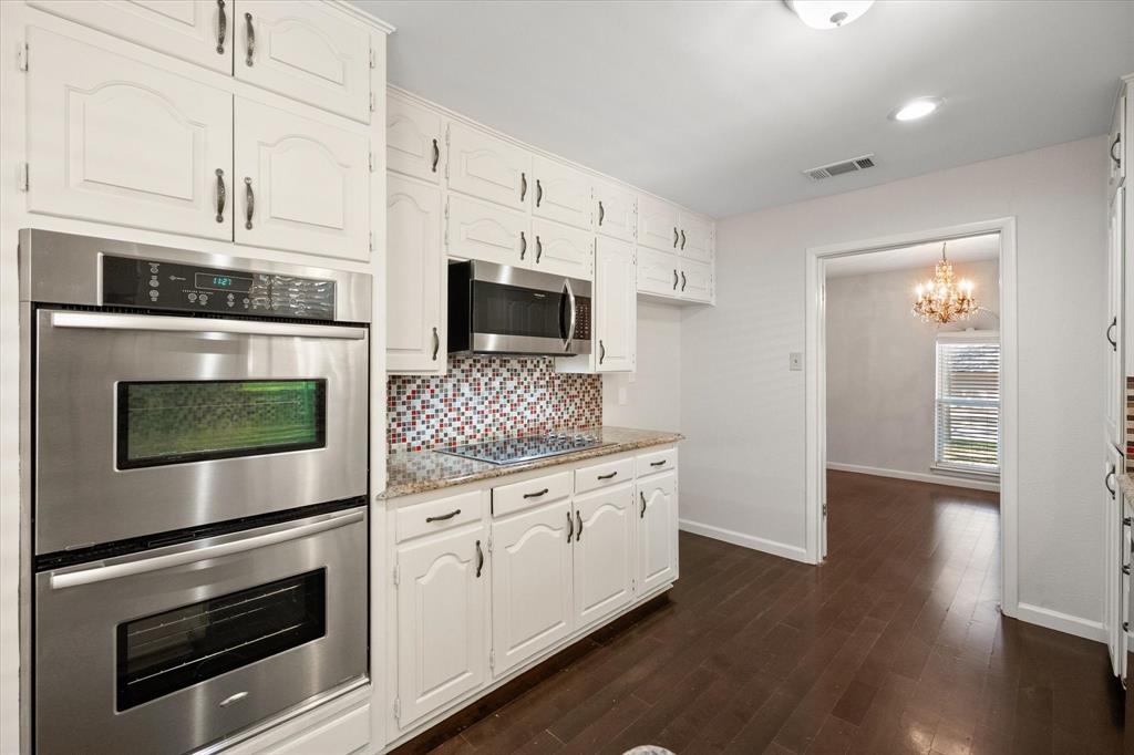 2003 Botts Drive Arlington, TX 76012 - Photo 10 of 40 a kitchen with stainless steel appliances white cabinets a stove and a microwave