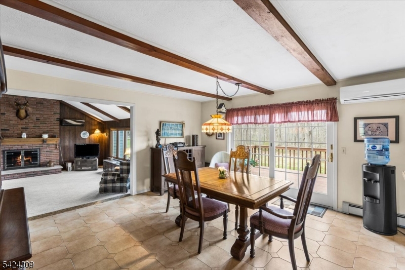 58 Andover Road Sparta, NJ 07871 - Photo 12 of 38 a dining room with furniture and a floor to ceiling window