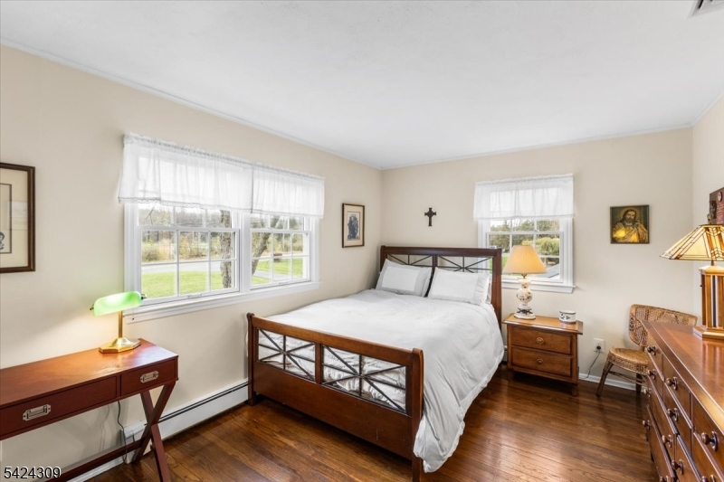 58 Andover Road Sparta, NJ 07871 - Photo 20 of 38 a bedroom with a bed window and a table in it