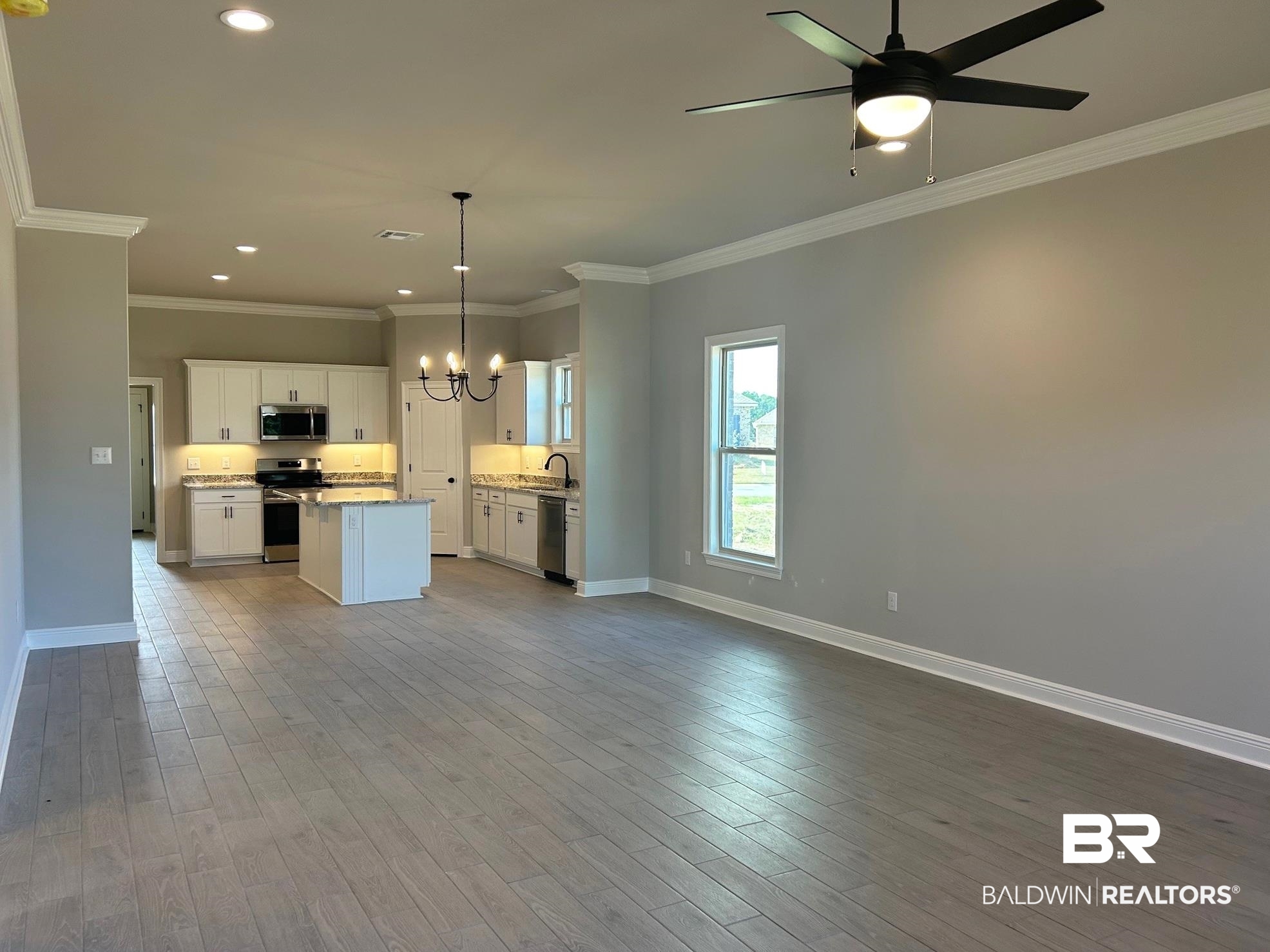 881 Sumter Loop Foley, AL 36535 - Photo 5 of 19 Kitchen featuring white cabinetry, pendant lighting, stainless steel appliances, and wood-type flooring