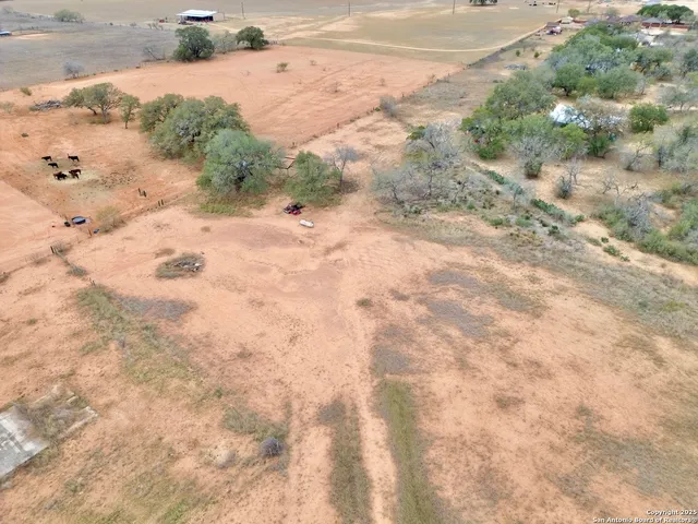 a view of a dry yard with snow on the road