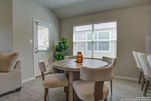 a dining room with furniture and window