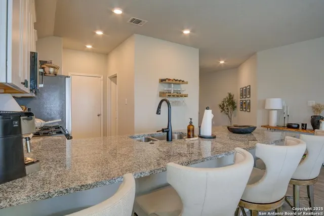 a bathroom with a granite countertop sink a toilet and a mirror