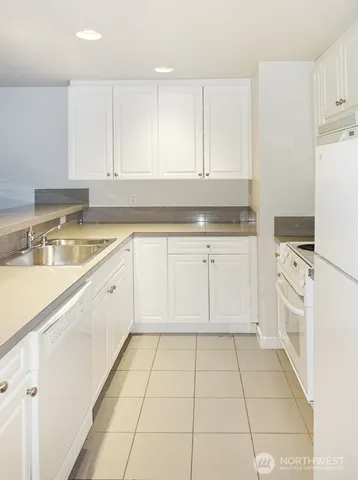 a kitchen with a sink a stove and cabinets
