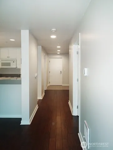 a view of a hallway with wooden floor