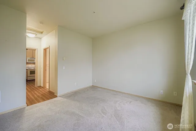 an empty room with closet and a bathroom