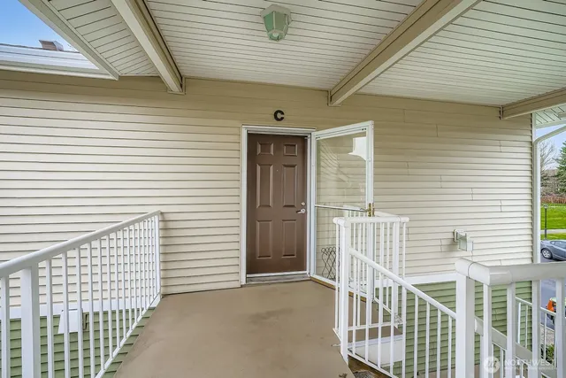 a view of a porch with wooden fence