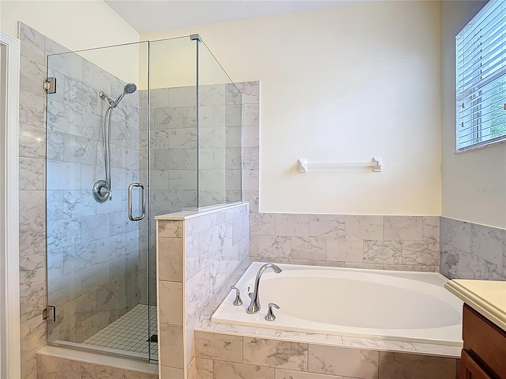 454 Winthrop Drive Spring Hill, FL 34609 - Photo 12 of 20 a bathroom with a bathtub and a shower