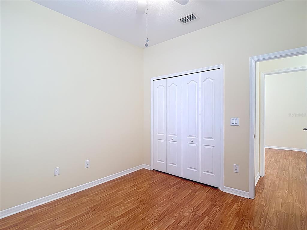 454 Winthrop Drive Spring Hill, FL 34609 - Photo 14 of 20 a view of an empty room with wooden floor