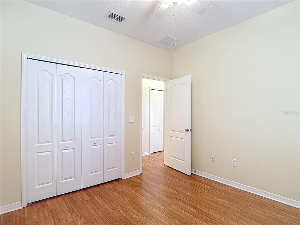 454 Winthrop Drive Spring Hill, FL 34609 - Photo 15 of 20 a view of an empty room with wooden floor