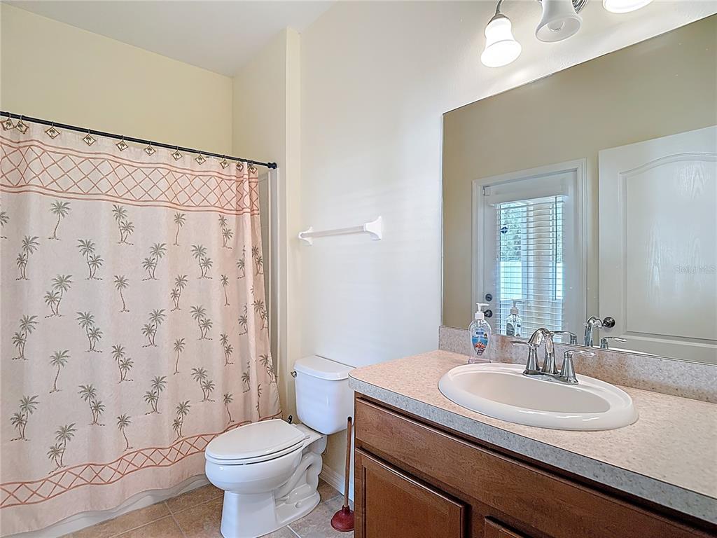 454 Winthrop Drive Spring Hill, FL 34609 - Photo 16 of 20 a bathroom with a granite countertop sink toilet and a mirror