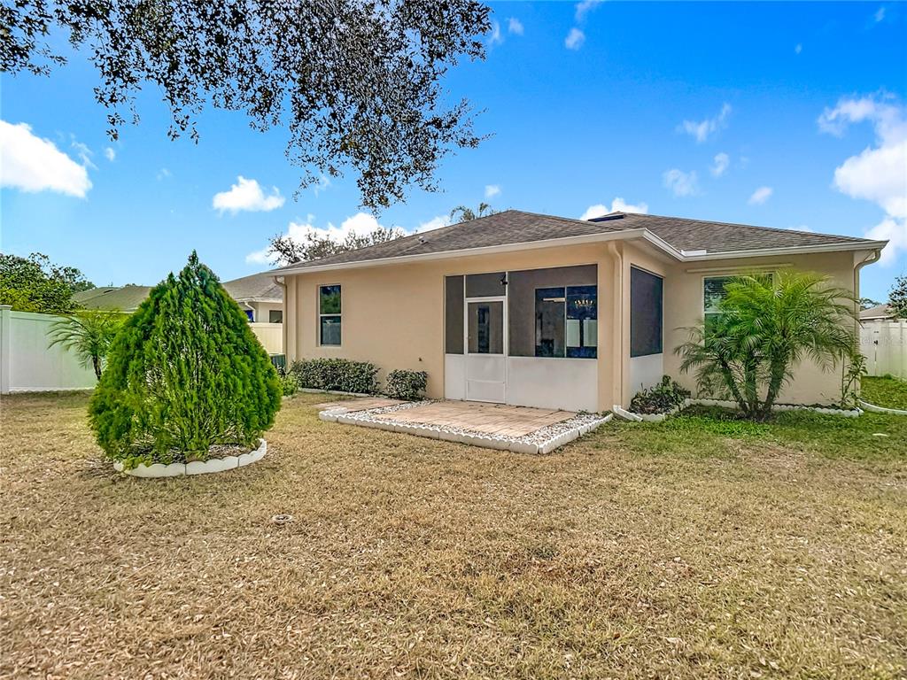 454 Winthrop Drive Spring Hill, FL 34609 - Photo 19 of 20 a view of a house with a yard and potted plants