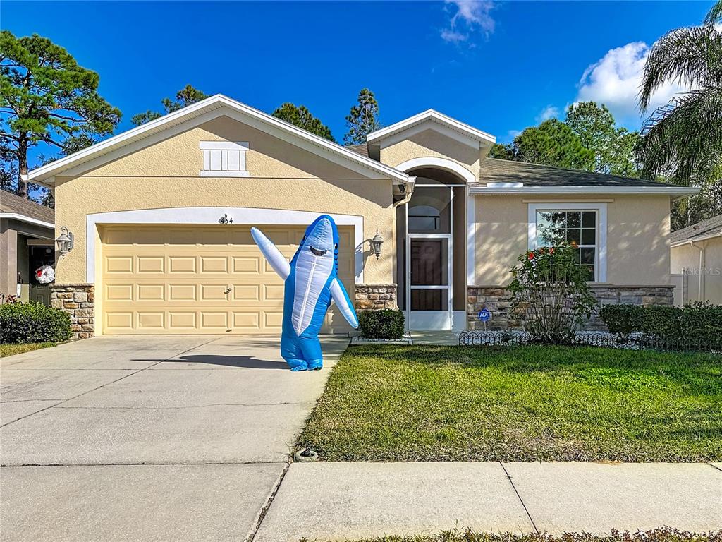 454 Winthrop Drive Spring Hill, FL 34609 - Photo 20 of 20 a front view of a house with a yard
