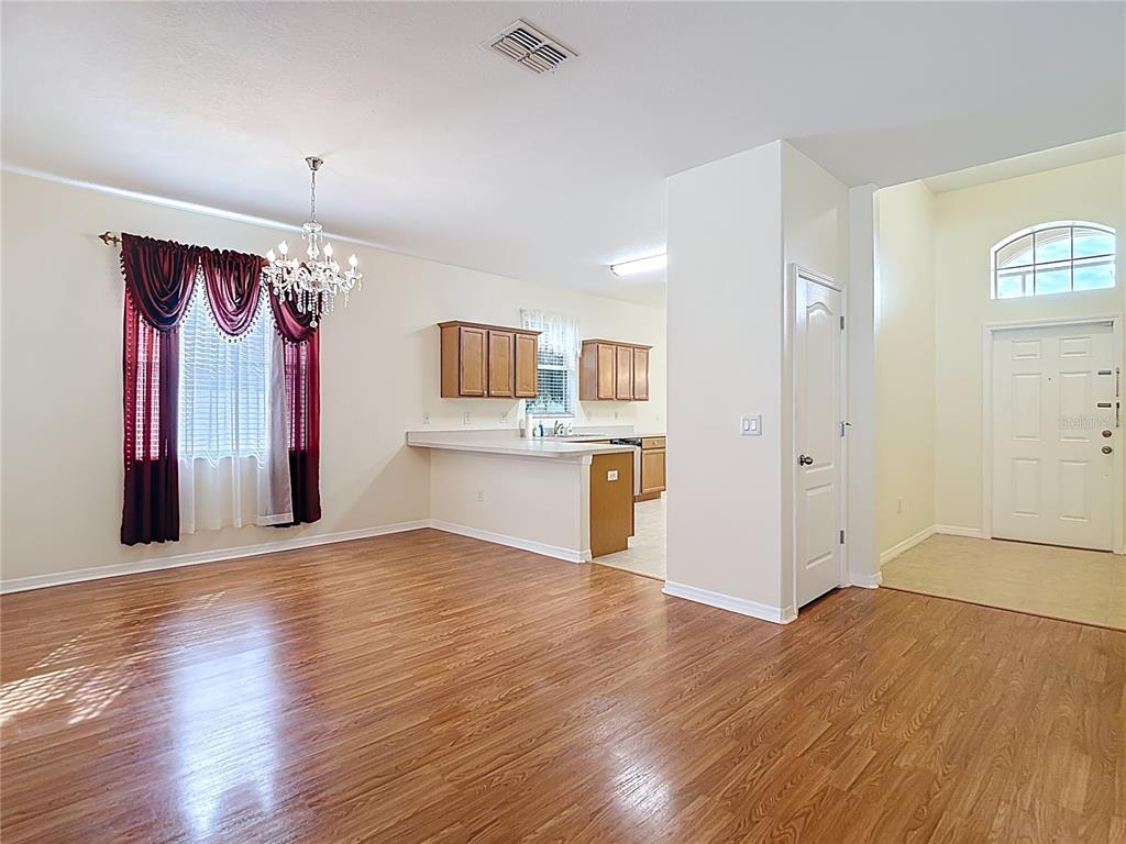 454 Winthrop Drive Spring Hill, FL 34609 - Photo 4 of 20 an empty room with wooden floor and windows