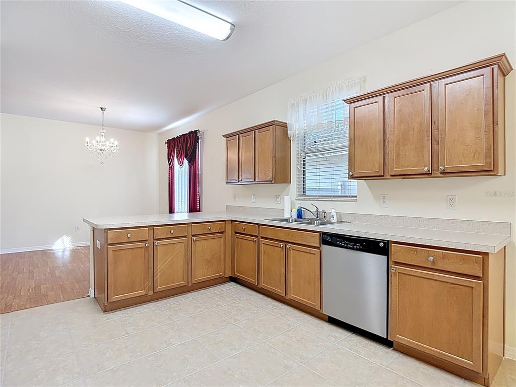 454 Winthrop Drive Spring Hill, FL 34609 - Photo 8 of 20 a kitchen with granite countertop cabinets sink and window