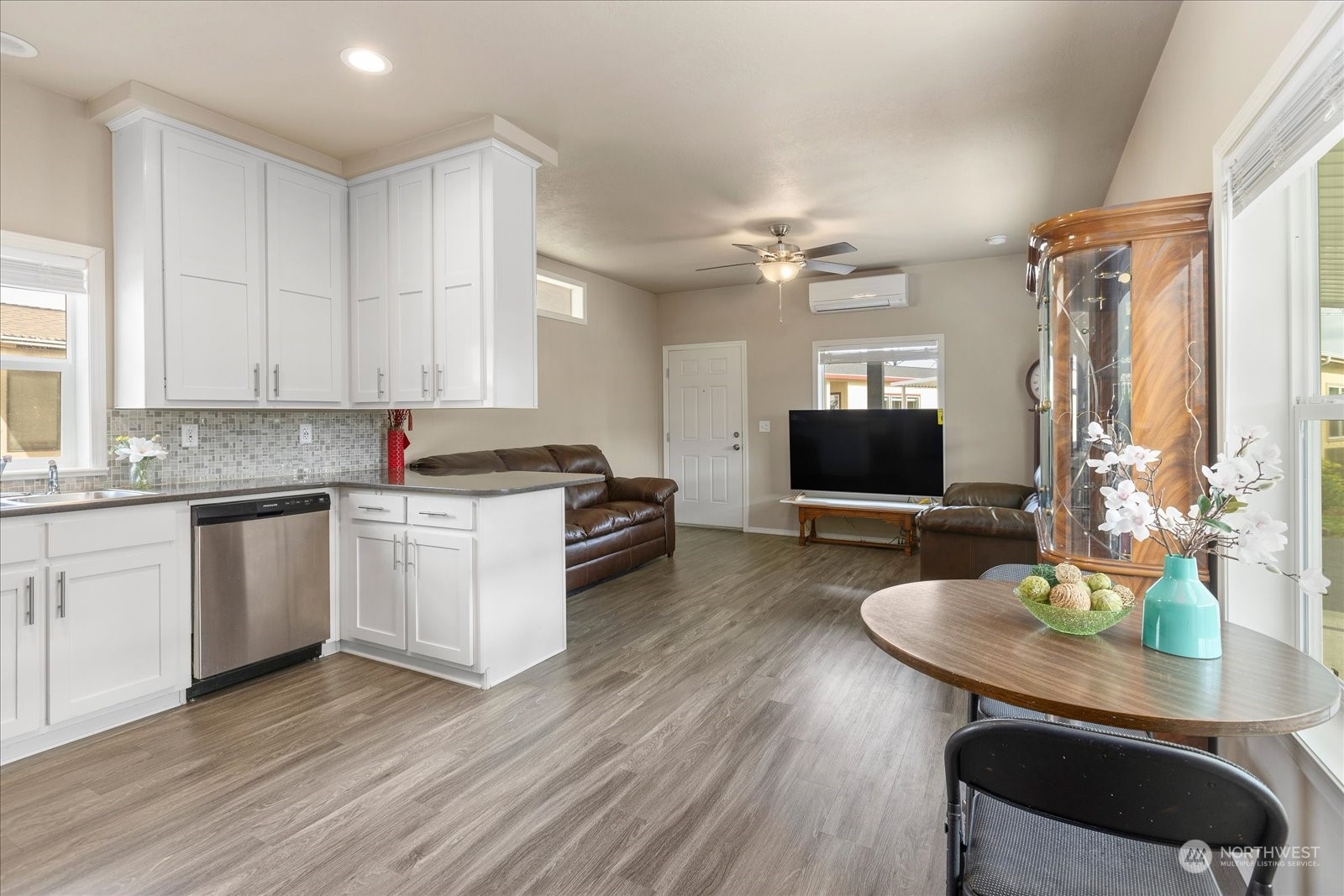 2101 South 324th Street, Unit 176 Federal Way, WA 98003 - Photo 12 of 33 a kitchen with granite countertop a stove a sink a dining table and chairs