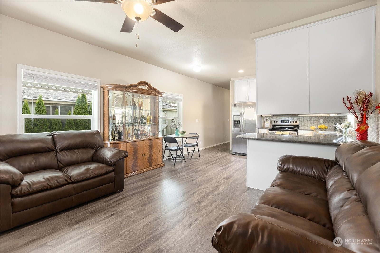 2101 South 324th Street, Unit 176 Federal Way, WA 98003 - Photo 6 of 33 a living room with furniture and a large window with kitchen view