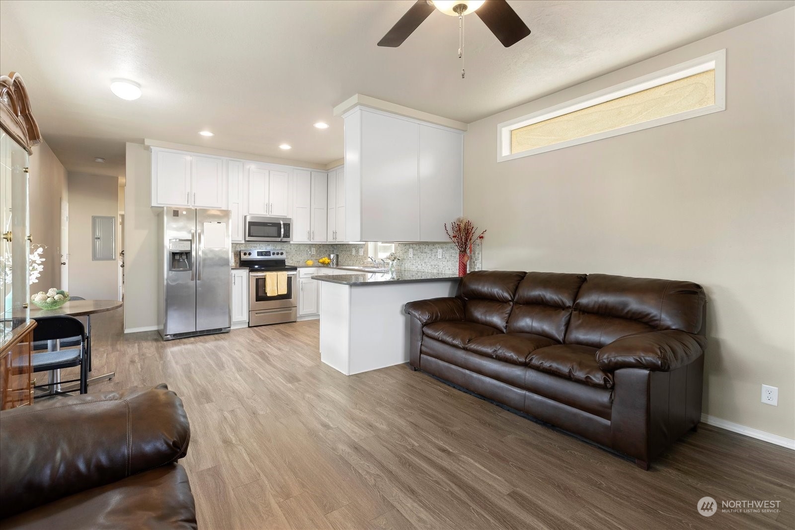 2101 South 324th Street, Unit 176 Federal Way, WA 98003 - Photo 7 of 33 a living room with stainless steel appliances kitchen island granite countertop furniture and a view of kitchen
