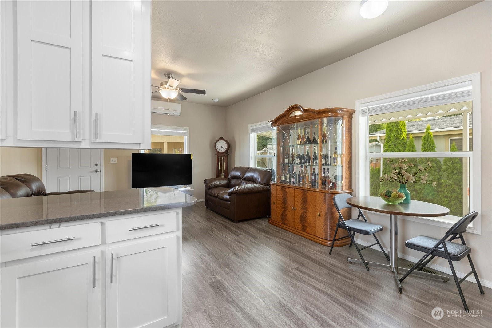 2101 South 324th Street, Unit 176 Federal Way, WA 98003 - Photo 9 of 33 a living room with furniture a flat screen tv and a floor to ceiling window