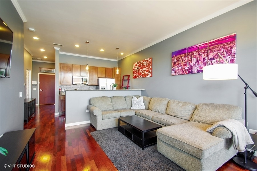 3920 North Sheridan Road, Unit 311 Chicago, IL 60613 - Photo 3 of 10 a living room with furniture and kitchen view
