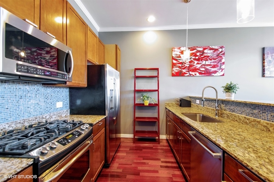 3920 North Sheridan Road, Unit 311 Chicago, IL 60613 - Photo 5 of 10 a kitchen with stainless steel appliances granite countertop a stove and a sink