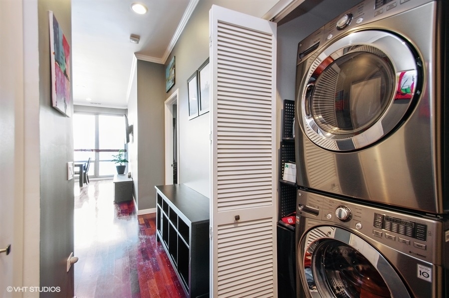 3920 North Sheridan Road, Unit 311 Chicago, IL 60613 - Photo 8 of 10 a view of a hallway with washer and dryer