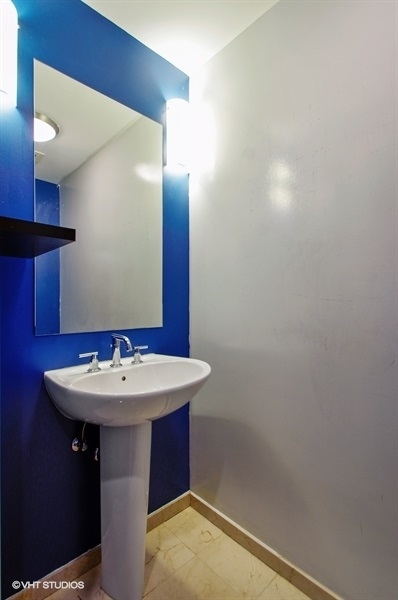 3920 North Sheridan Road, Unit 311 Chicago, IL 60613 - Photo 9 of 10 a bathroom with a sink and a mirror