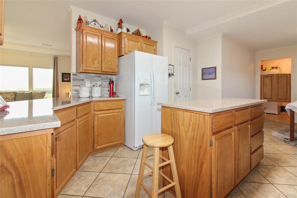 455 Hughes Cemetery Road Italy, TX 76651 - Photo 13 of 40 a kitchen with stainless steel appliances a refrigerator sink and white cabinets