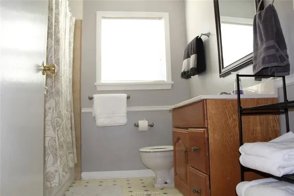 a bathroom with a toilet sink and shower