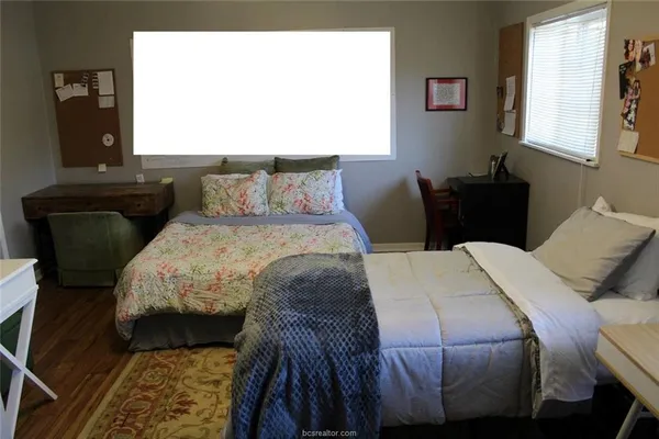 a bedroom with a bed and window