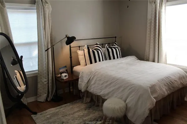 a bed sitting in a bedroom next to a window