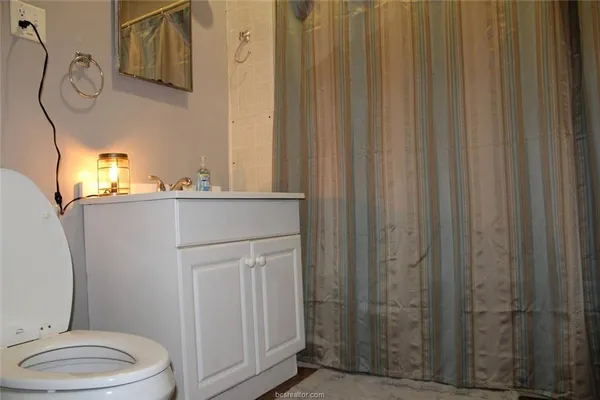 a bathroom with a toilet a sink and tub