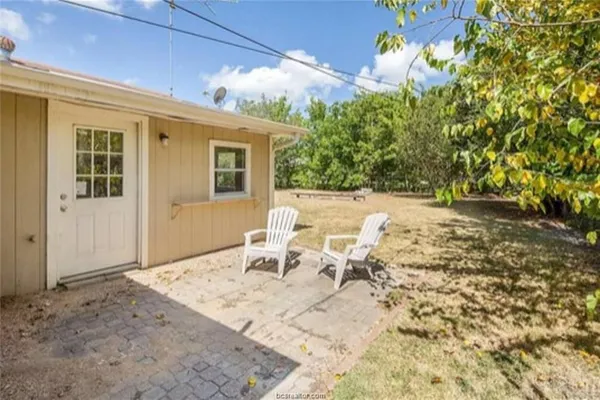 a view of a patio with table and chairs and potted plants