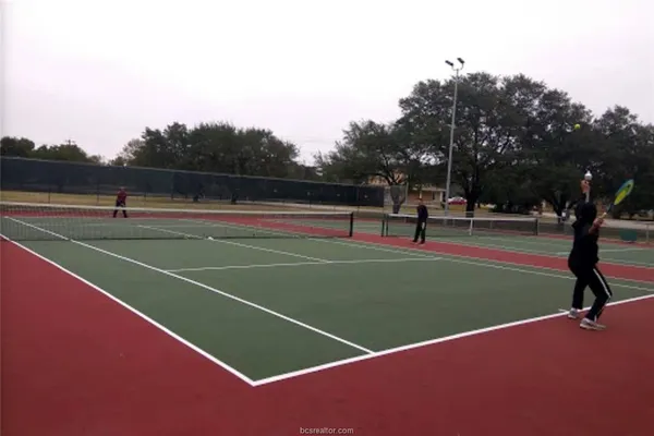 a view of tennis court with chairs