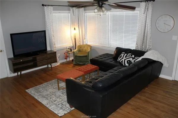 a living room with furniture and a flat screen tv