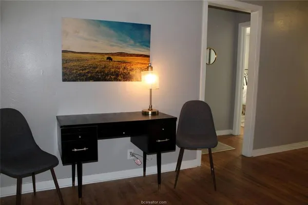 a living room with a chair and a potted plant