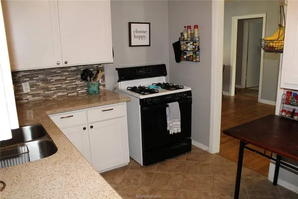 a kitchen with stainless steel appliances granite countertop a stove and a refrigerator