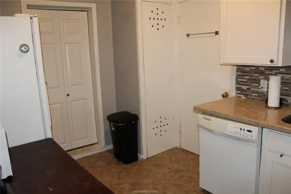 a view of a storage and utility room with closet