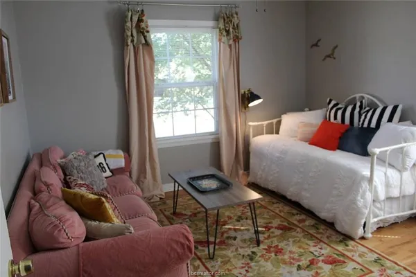 a bedroom with furniture and a window