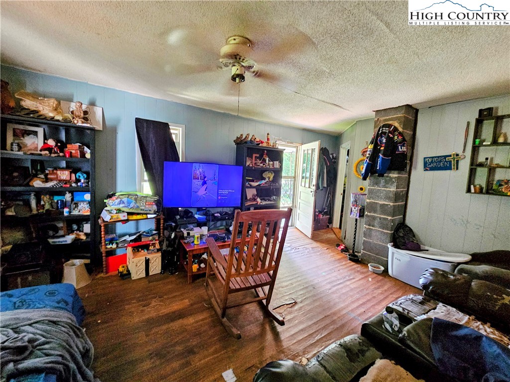 785 West Deep Ford Road Lansing, NC 28643 - Photo 7 of 21 a living room with lots of furniture and a wooden floor