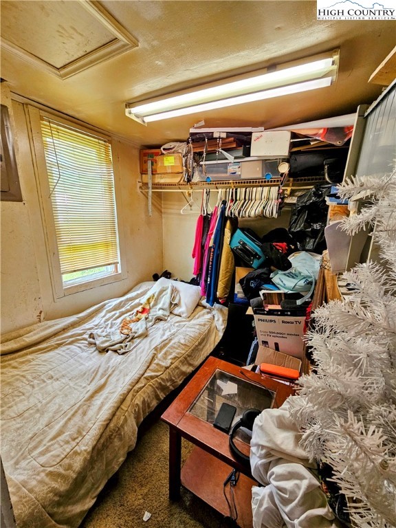 785 West Deep Ford Road Lansing, NC 28643 - Photo 10 of 21 a bed sitting in a bedroom next to a window