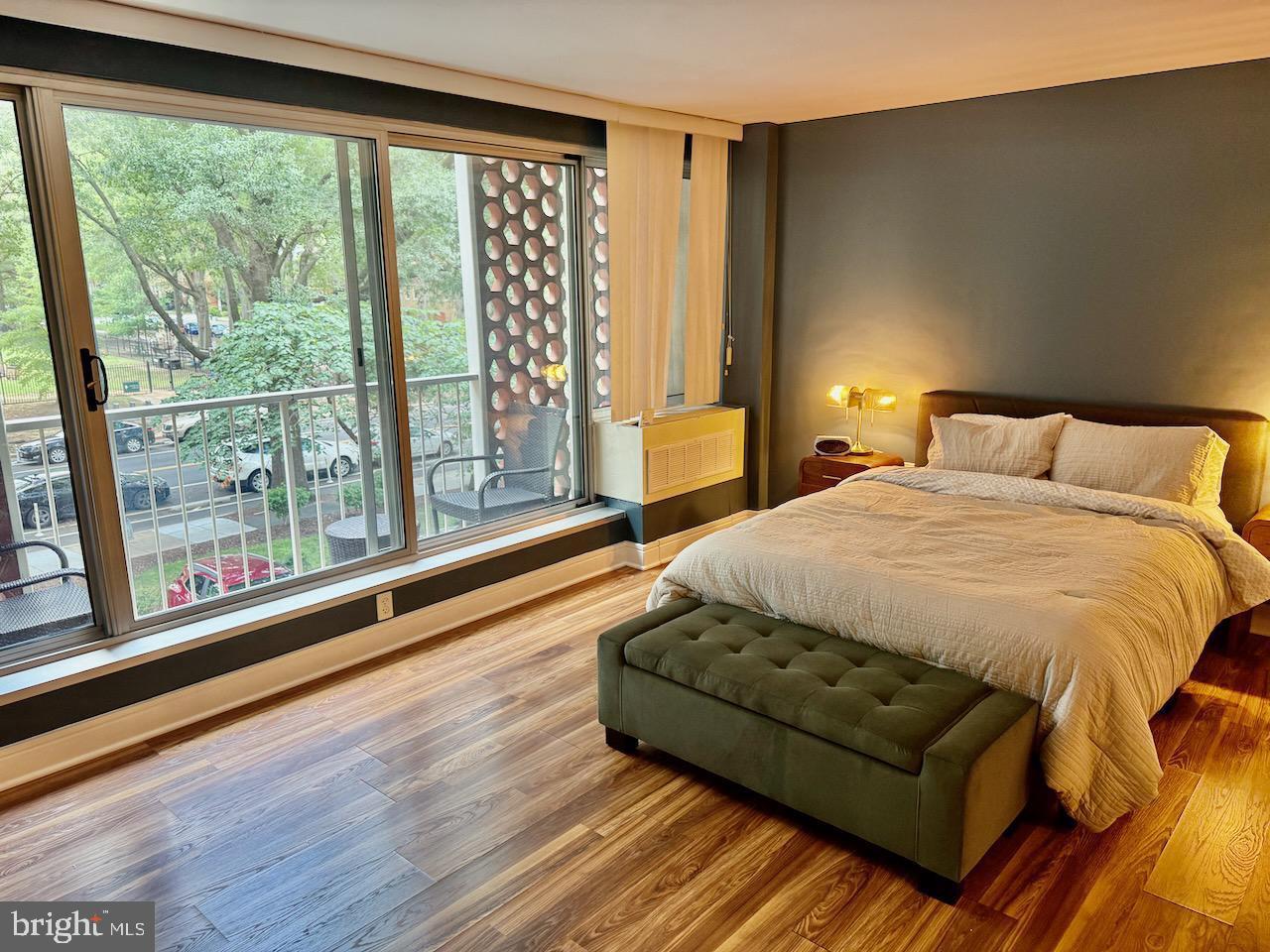 800 4th Street Southwest, Unit N123 Washington, DC 20024 - Photo 4 of 11 Serene bedroom with vibrant outdoor views.