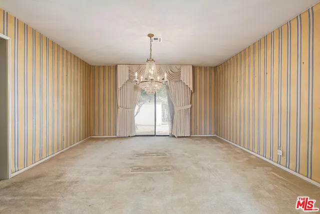 a kitchen with stainless steel appliances granite countertop a stove a sink dishwasher and cabinets with wooden floor