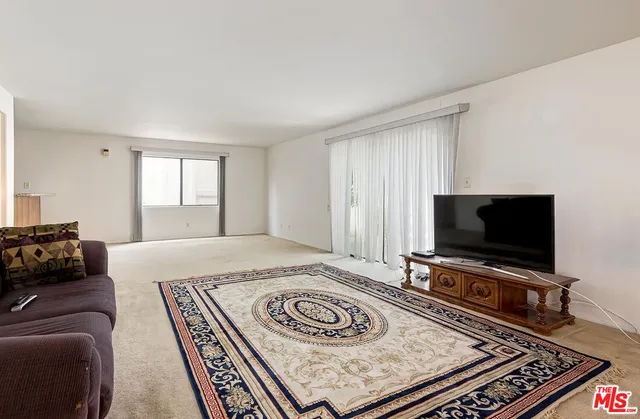 a view of a livingroom with furniture and a flat screen tv
