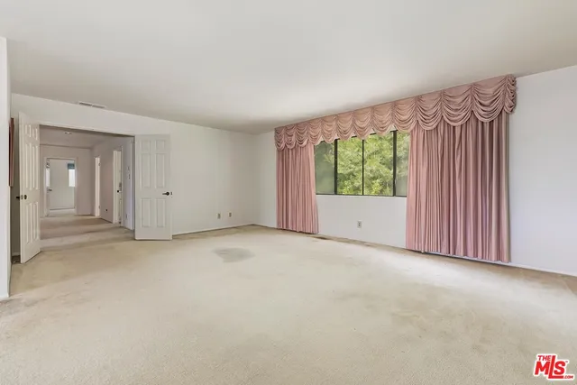 a spacious bathroom with a double vanity sink and mirror