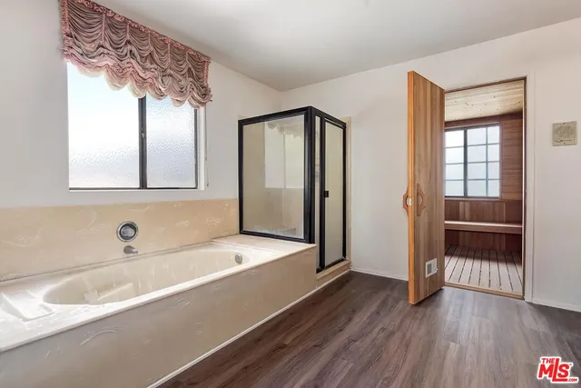 a view of wooden door and furniture in a room