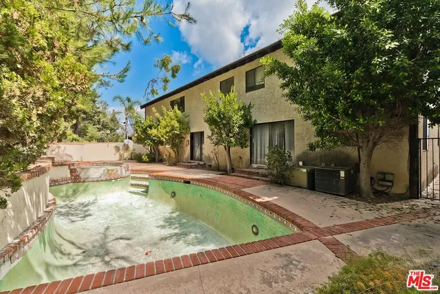 a view of a house with basketball court