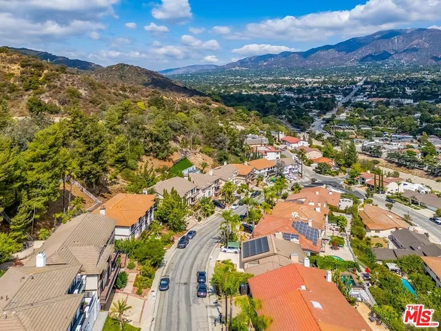 an aerial view of residential houses with outdoor space